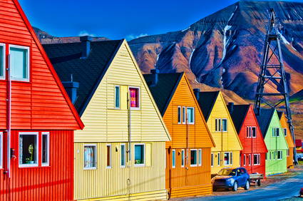 Digitally enhanced row of very colorful homes in Longyearbyen, Svalsbard, Norway.